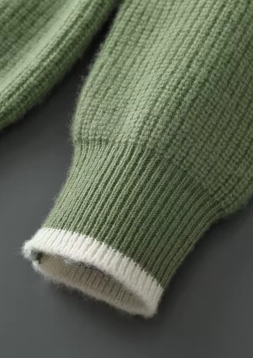 Close-up of the knit detail on a men's crew neck sweater, highlighting its quality and soft feel.