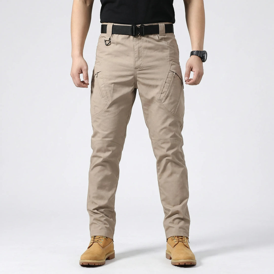 Rugged men's tactical cargo pants, 9 pockets, durable & flexible, great for hiking, camping, adventure.