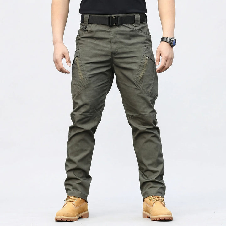 Flexible men's tactical cargo pants for outdoor adventure, featuring 9 durable multi-purpose pockets.