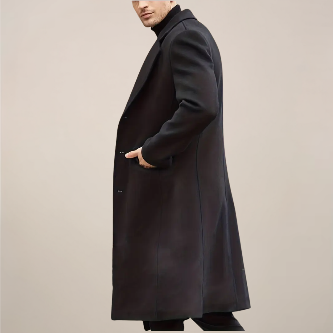 Close-up of a men's black tailored single-breasted winter overcoat, showcasing its premium fabric.