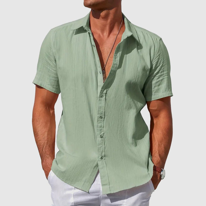 Stylish man wearing a textured short sleeve button top, perfect for summer casual outings.