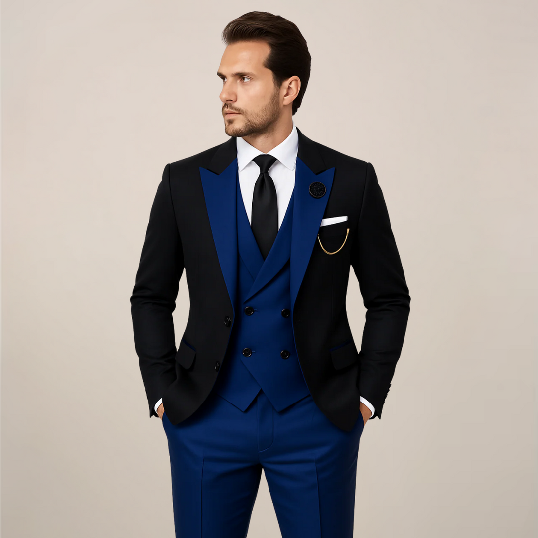 Classic men's black three-piece dinner suit, tailored with striking contrast lapels for formal events & weddings.