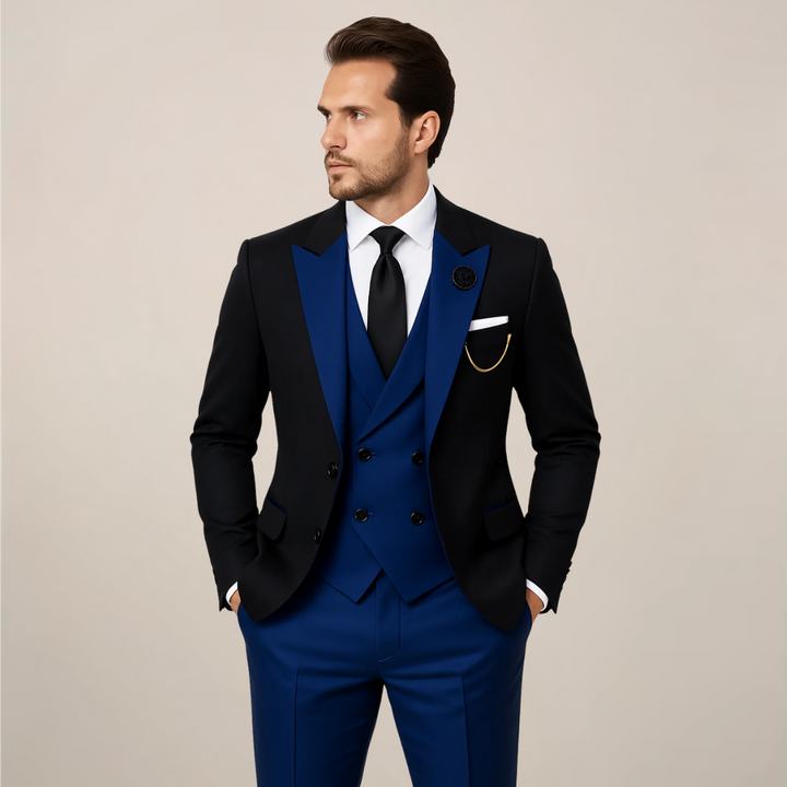 Classic men's black three-piece dinner suit, tailored with striking contrast lapels for formal events & weddings.