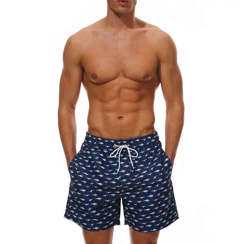 Dark blue men's tropical swim trunks featuring a lively pineapple pattern for summer.