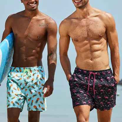 Green men's tropical swim trunks with a fashionable pineapple print, ideal for resort wear.