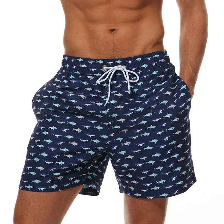 Men's black tropical swim trunks with a stylish pineapple print, perfect for resort wear.