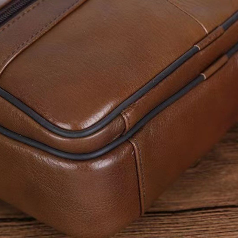 Durable men's messenger bag in black, offering spacious storage and a comfortable cross-body fit.