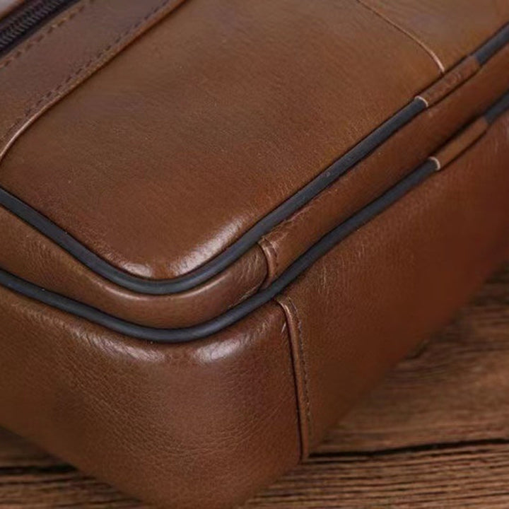 Durable men's messenger bag in black, offering spacious storage and a comfortable cross-body fit.