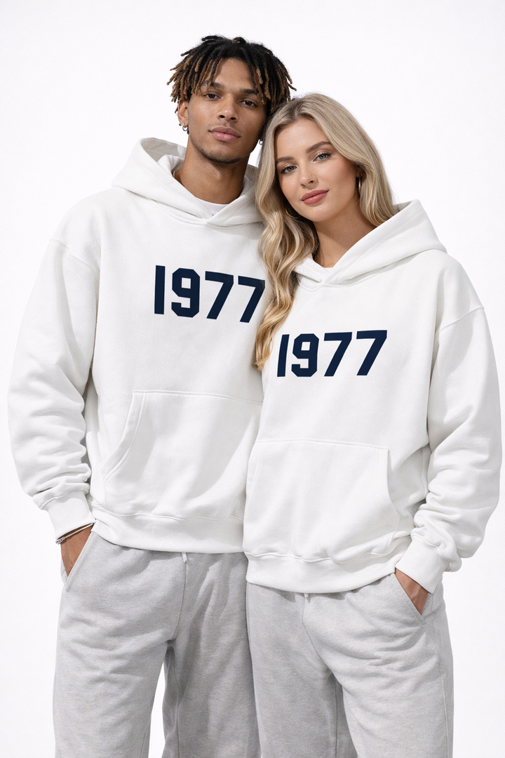 Man modeling men's vintage 1977 raglan sleeve hoodie. Casual streetwear pullover for urban fashion.