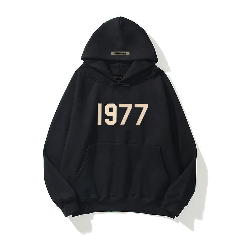 Man wearing vintage 1977 streetwear hoodie. Casual raglan sleeve pullover for urban fashion.