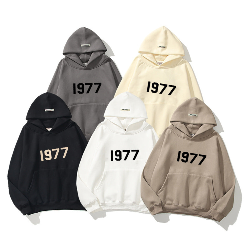 Cozy men's 1977 vintage hoodie. Raglan sleeve pullover, perfect for cool weather streetwear.