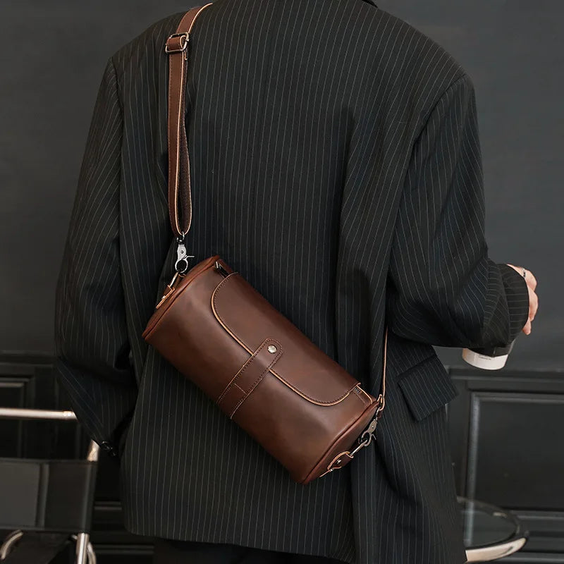 Men's vintage PU leather barrel shoulder bag, stylish and versatile for daily carry.