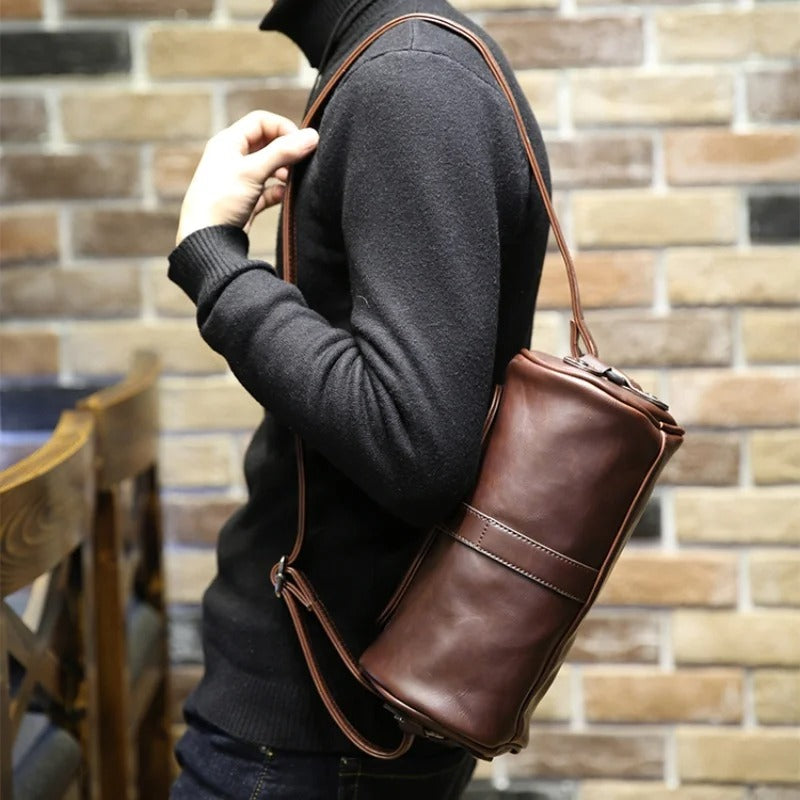 Men's vintage barrel shoulder bag, PU leather, with adjustable strap, ideal for daily carry.