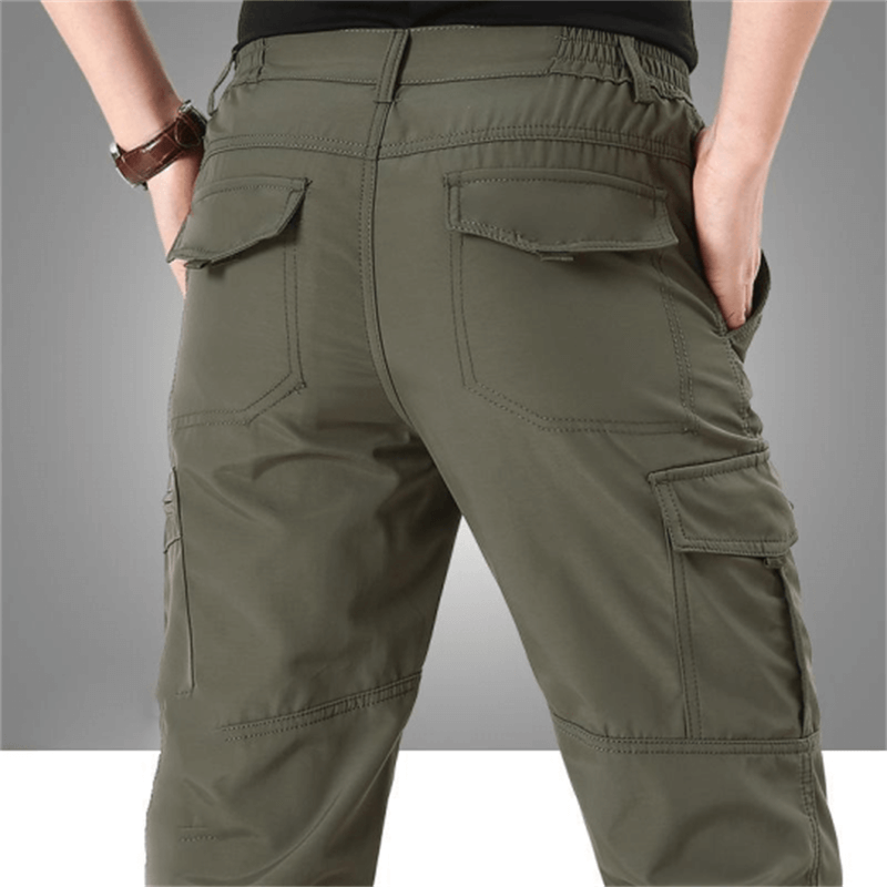 Rugged men's waterproof tactical cargo pants for outdoor hiking and adventure.