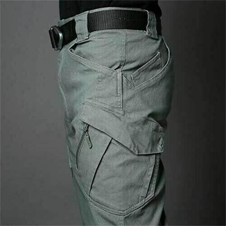 Functional men's waterproof tactical cargo pants with multi-pockets for outdoor use.
