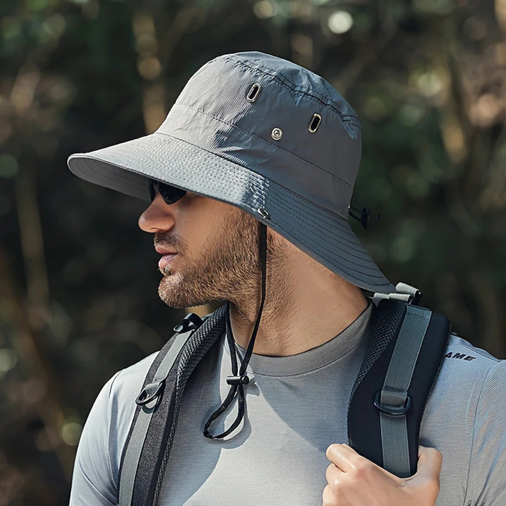 Stylish men's wide brim outdoor hat with chin strap for reliable sun protection during travel or fishing trips.