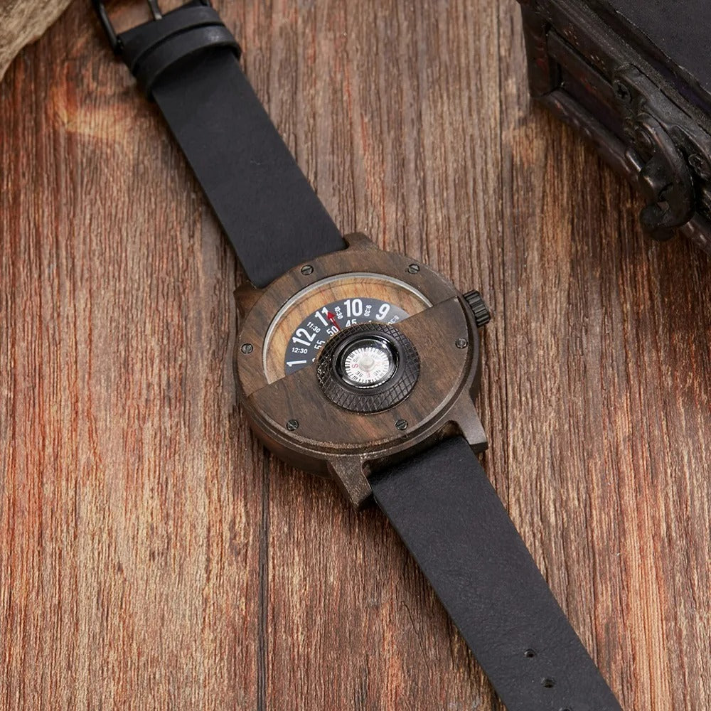 Close-up of a men's wood watch showing its unique grain, leather strap texture, & functional compass.
