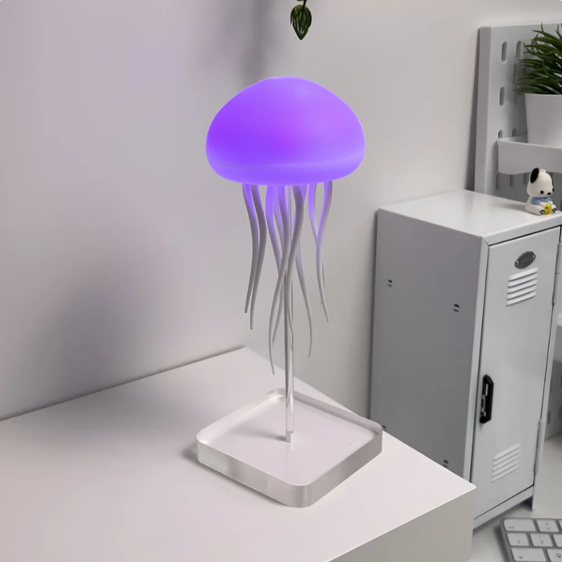 Close-up of a vibrant LED jellyfish lamp in action, glowing with dynamic color changes on a modern desk.