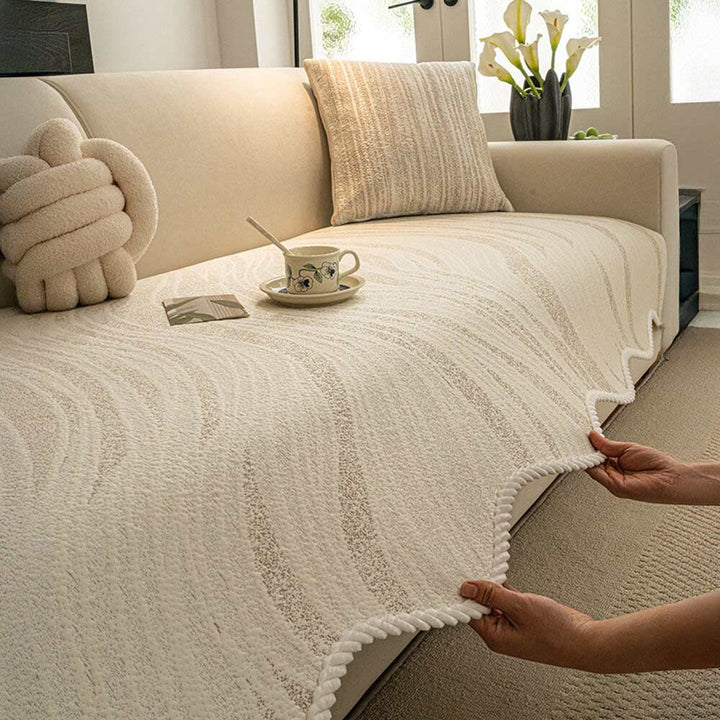 Minimalist ice silk couch cover with braided edge, light gray, draped over a sofa, cool comfort