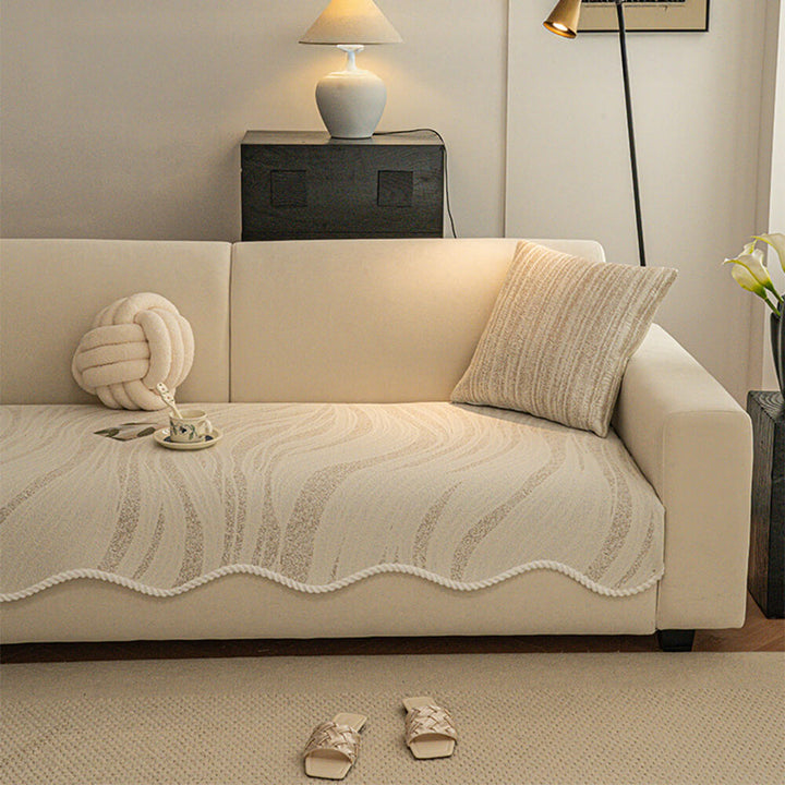 Full view of a living room with a minimalist ice silk sofa protector, light and airy, pet friendly