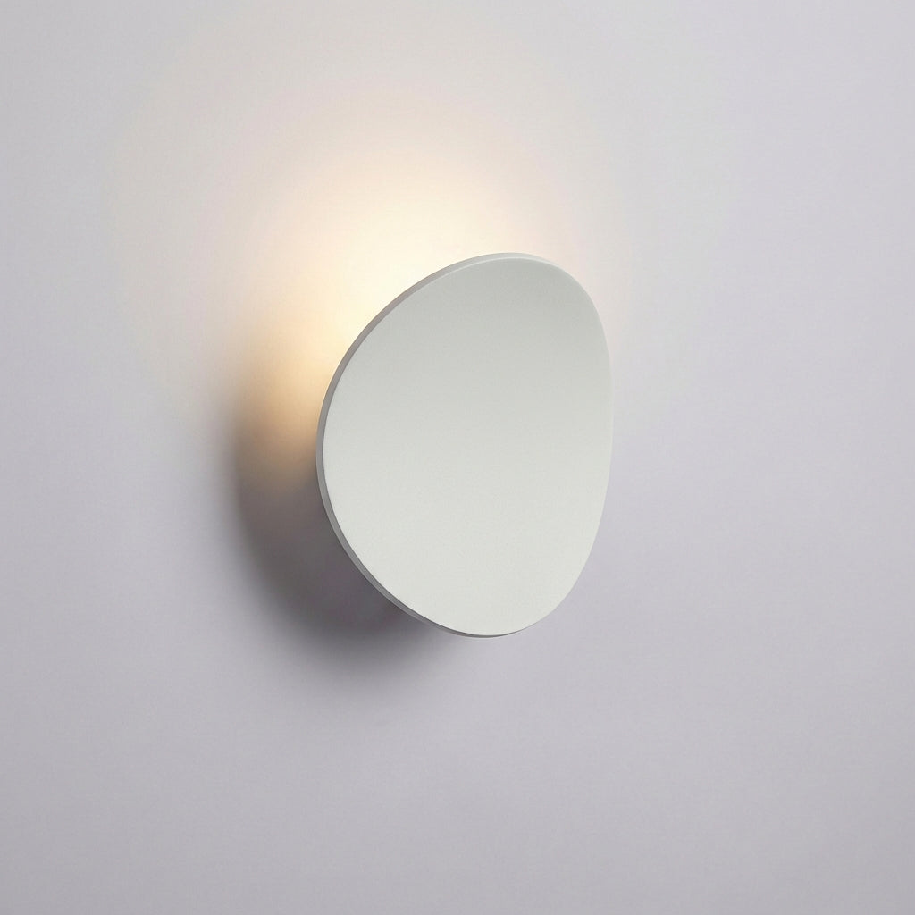 Aluminum LED wall sconce, Serevex, a modern minimalist uplight for energy-efficient ambient light in any room.