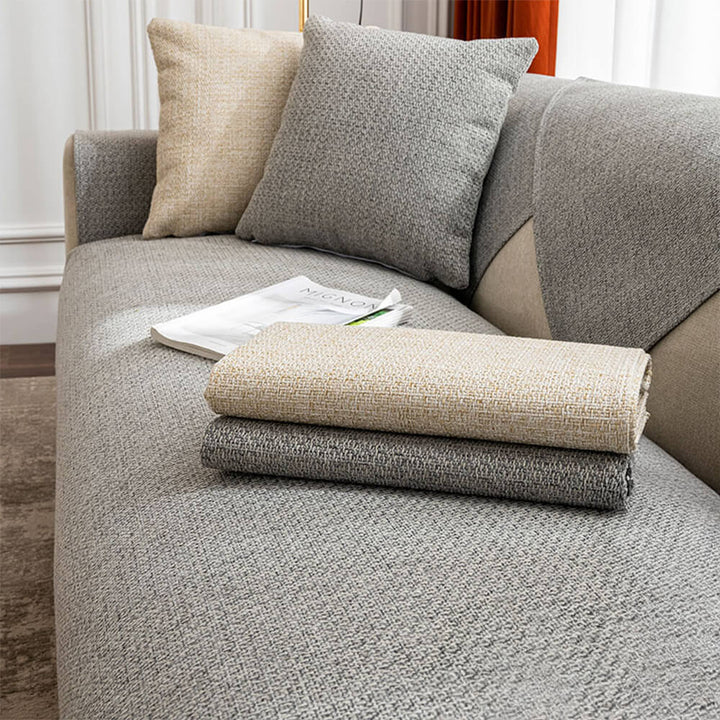 Beige solid color couch cover, breathable and minimalist, enhancing living room comfort and decor.