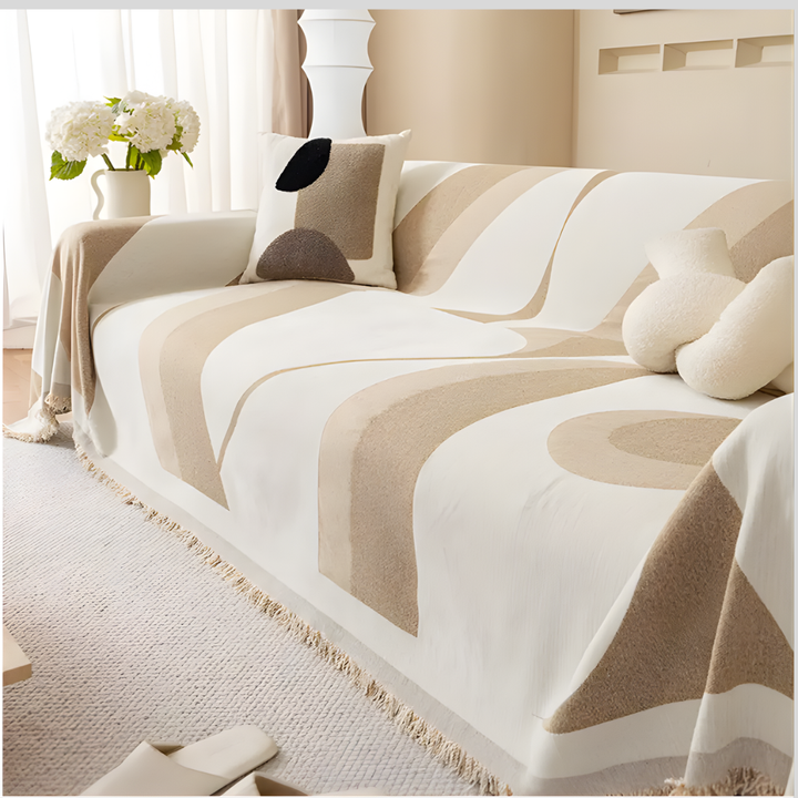 Close-up of a premium chenille sofa cover featuring a modern art pattern, with non-slip grip on furniture.