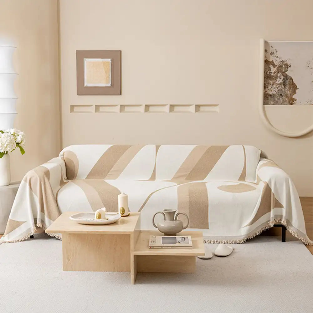 Full view of a living room with a new chenille universal fit sofa cover, cozy and inviting