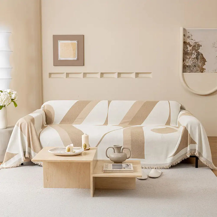 Full view of a living room with a new chenille universal fit sofa cover, cozy and inviting