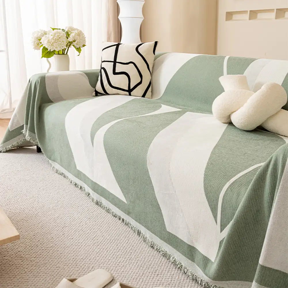 Universal fit chenille couch cover draped over a three-seater sofa, perfect for pet owners