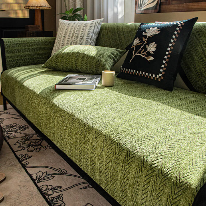 Modern chenille sofa cover in a neutral color, protecting a sectional couch from pet scratches.