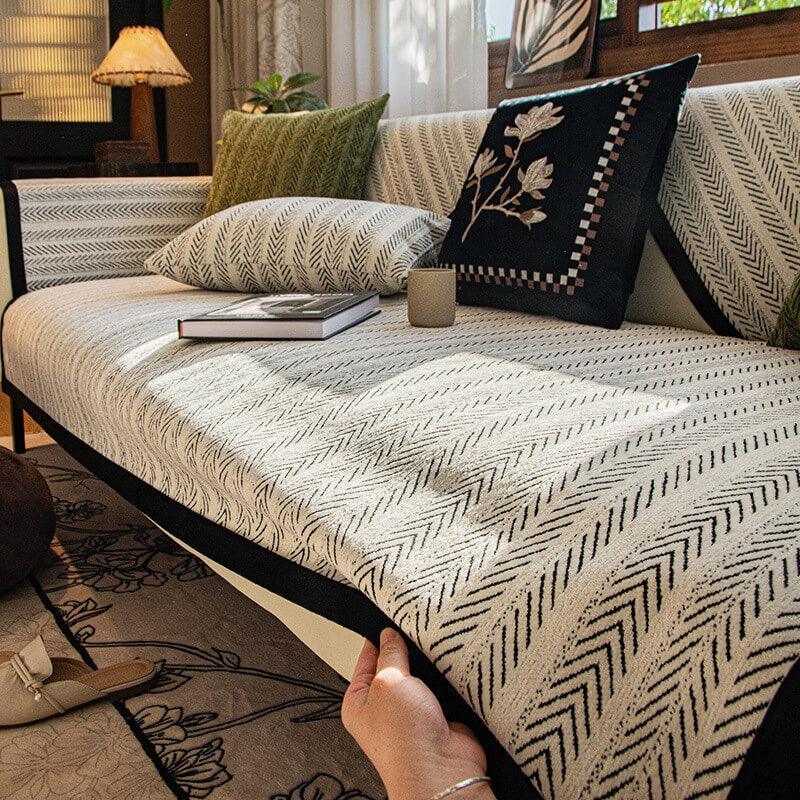Non-slip chenille sofa cover draped over a three-seater couch, ideal for pet-friendly homes.