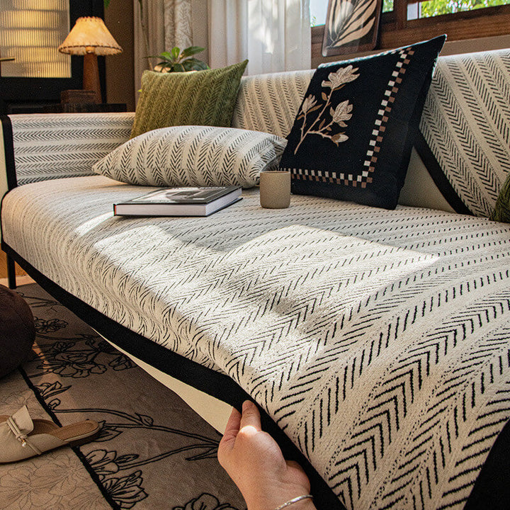 Non-slip chenille sofa cover draped over a three-seater couch, ideal for pet-friendly homes.