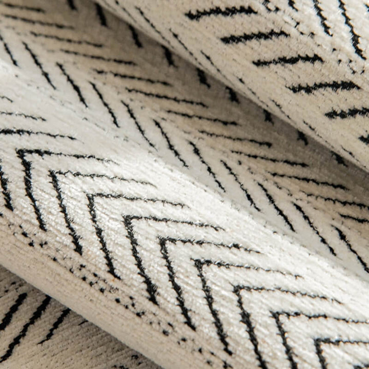Close-up of the textured chenille fabric of a sofa cover, designed for comfort and durability.