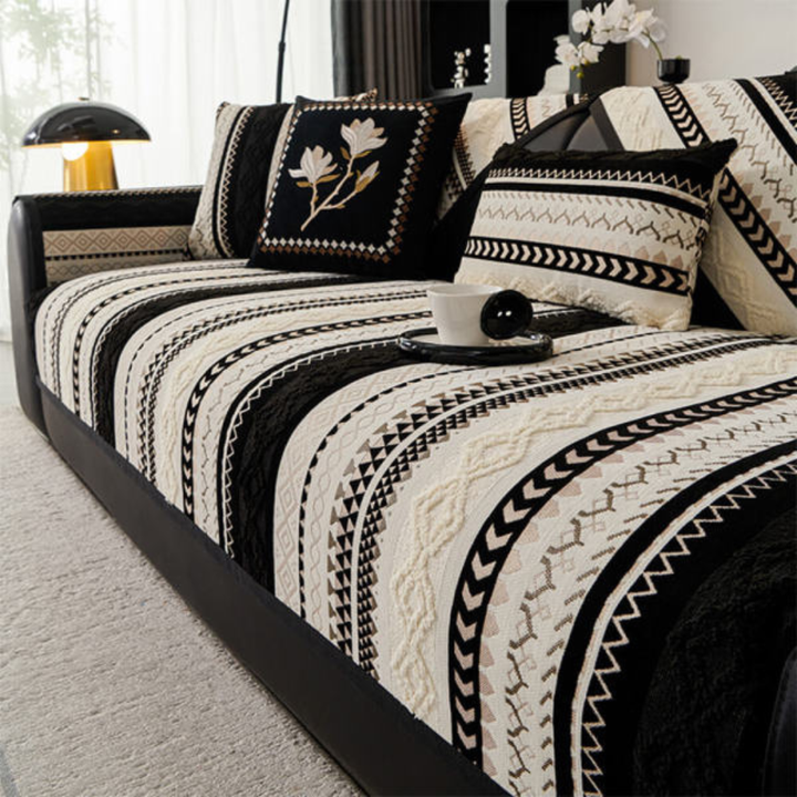 Full view of a living room with a couch protected by a stylish color block suede sofa cover