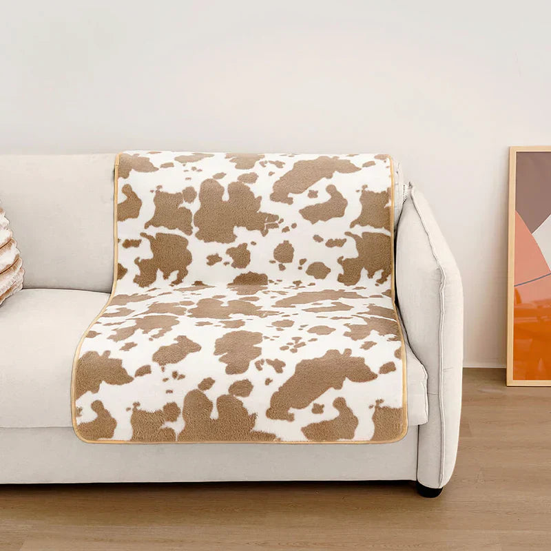 Washable modern cow print pet throw, ideal for protecting furniture and adding home decor charm