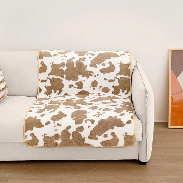 Washable modern cow print pet throw, ideal for protecting furniture and adding home decor charm