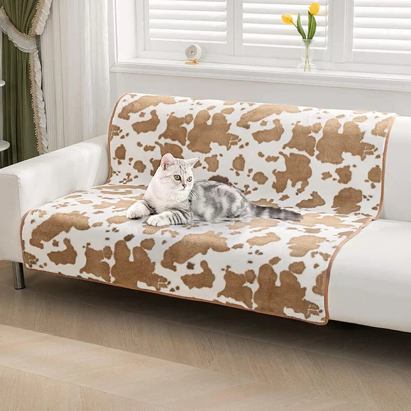 Cozy cow print pet blanket, a chic furniture protector and comfortable dog or cat bed alternative