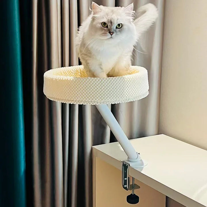 Sustainable pet furniture: desk-mounted cat bed with a washable cushion, easy to maintain.
