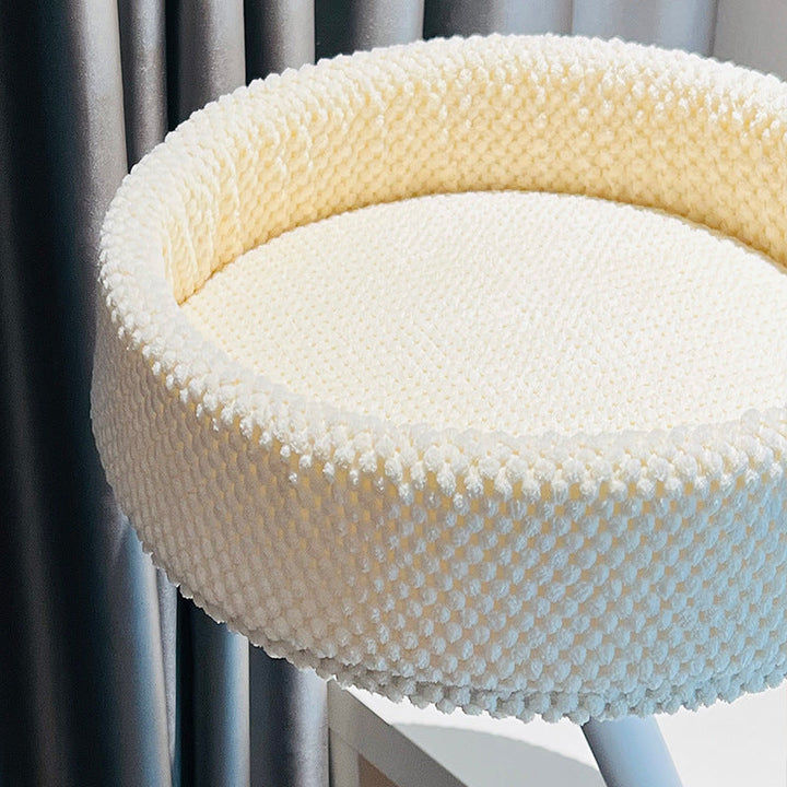 Showcasing the compact design of a desk-mounted cat bed, a smart solution for small workspaces.