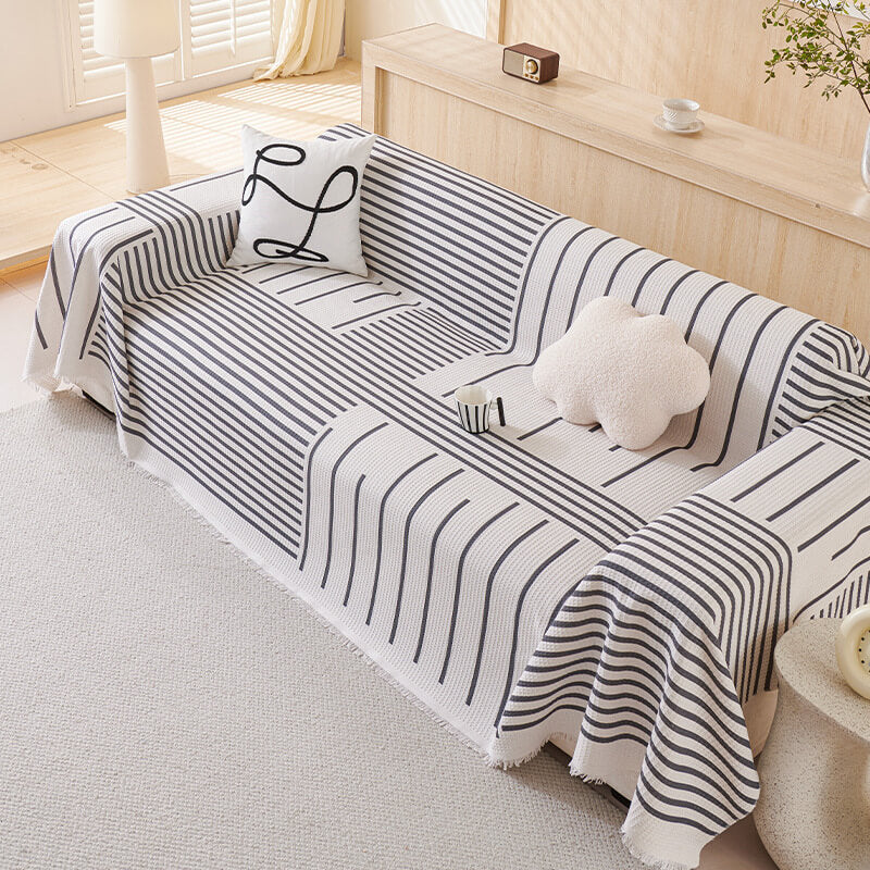 Multi-color geometric sofa cover protecting furniture in a contemporary living room