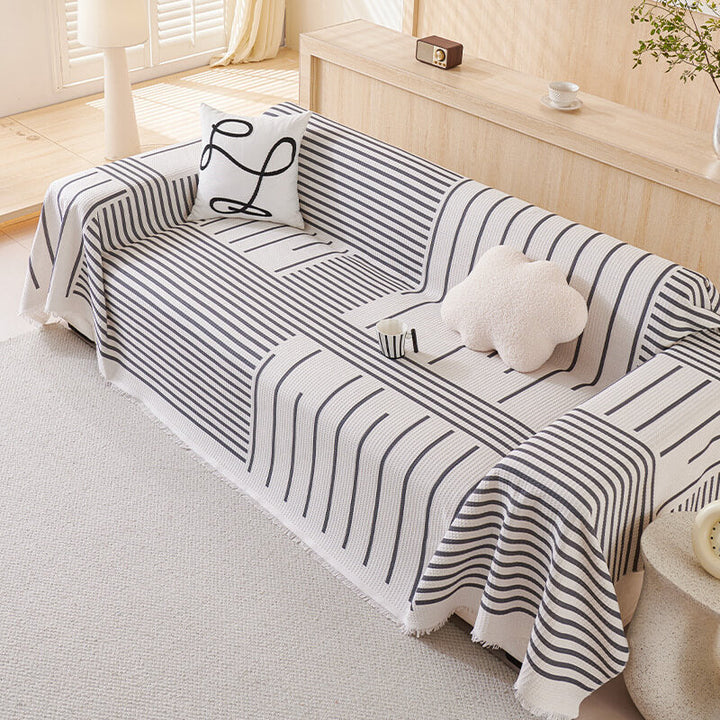 Multi-color geometric sofa cover protecting furniture in a contemporary living room