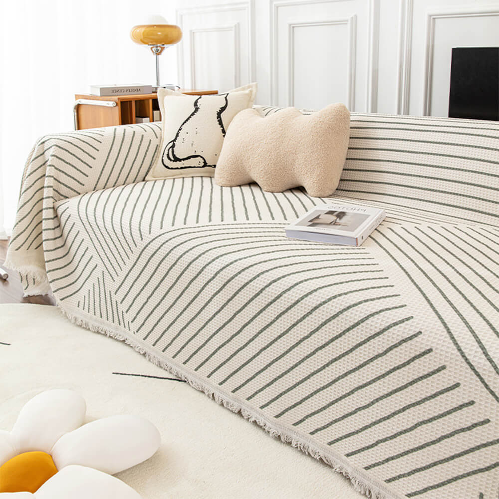 Stylish geometric multi-color couch cover draping a sofa, enhancing living room decor