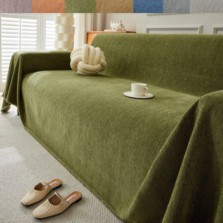 Full view of a living room with a sectional sofa covered by a modern geometric stretch cover