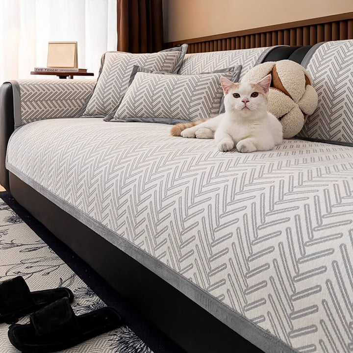 Close-up of herringbone pattern on a cozy chenille sofa protector, showcasing texture and quality.