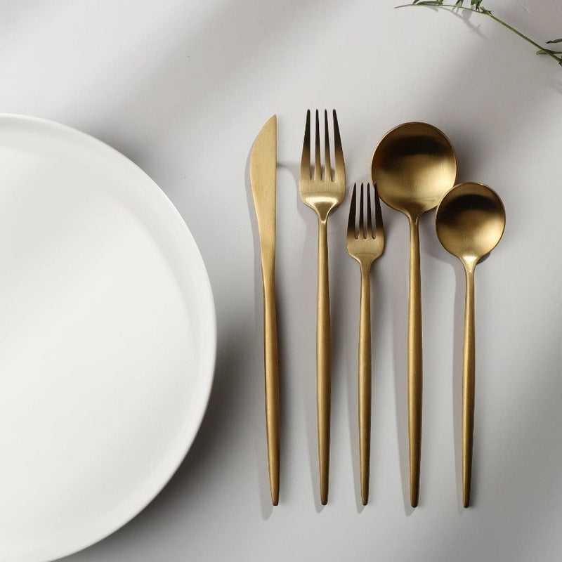 Gold minimalist tableware set for sophisticated entertaining. Elegant dining decor.
