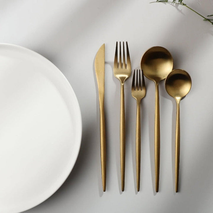 Gold minimalist tableware set for sophisticated entertaining. Elegant dining decor.