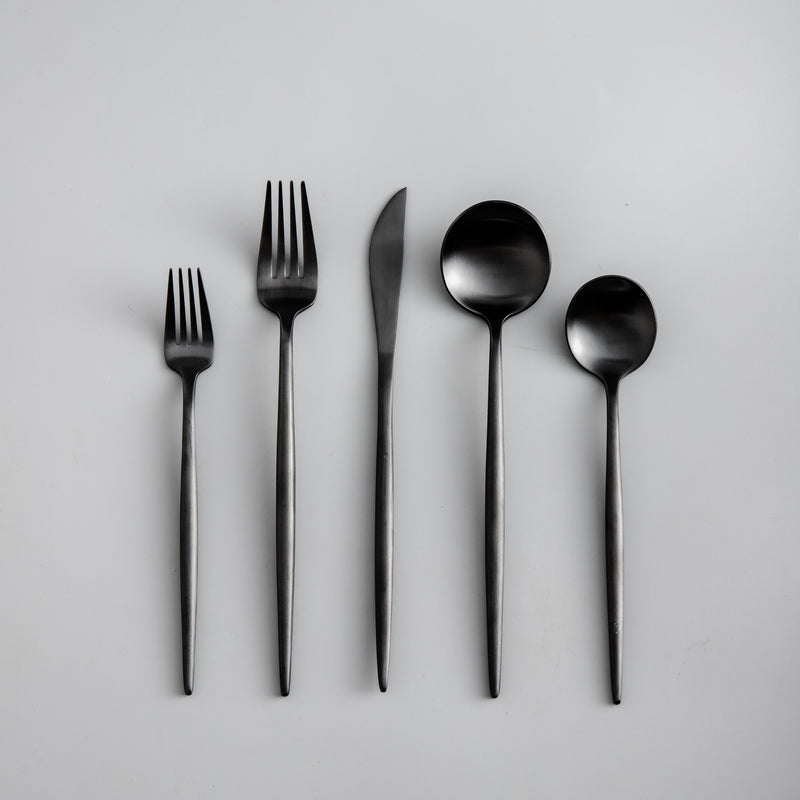 Modern silverware set with a refined matte black finish. Minimalist dining essential.