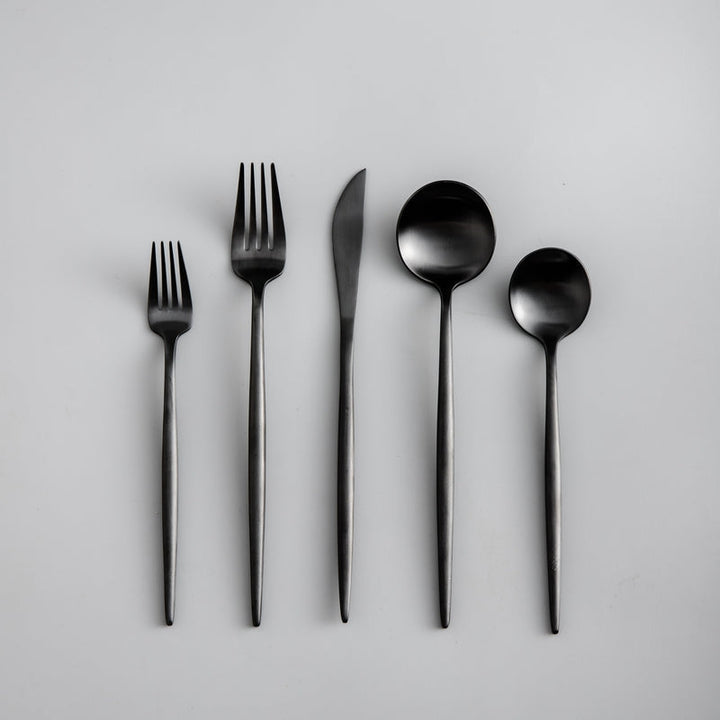 Modern silverware set with a refined matte black finish. Minimalist dining essential.