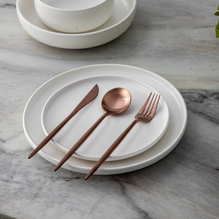 Minimalist gold cutlery for refined table settings and events. Elegant dining accessory.